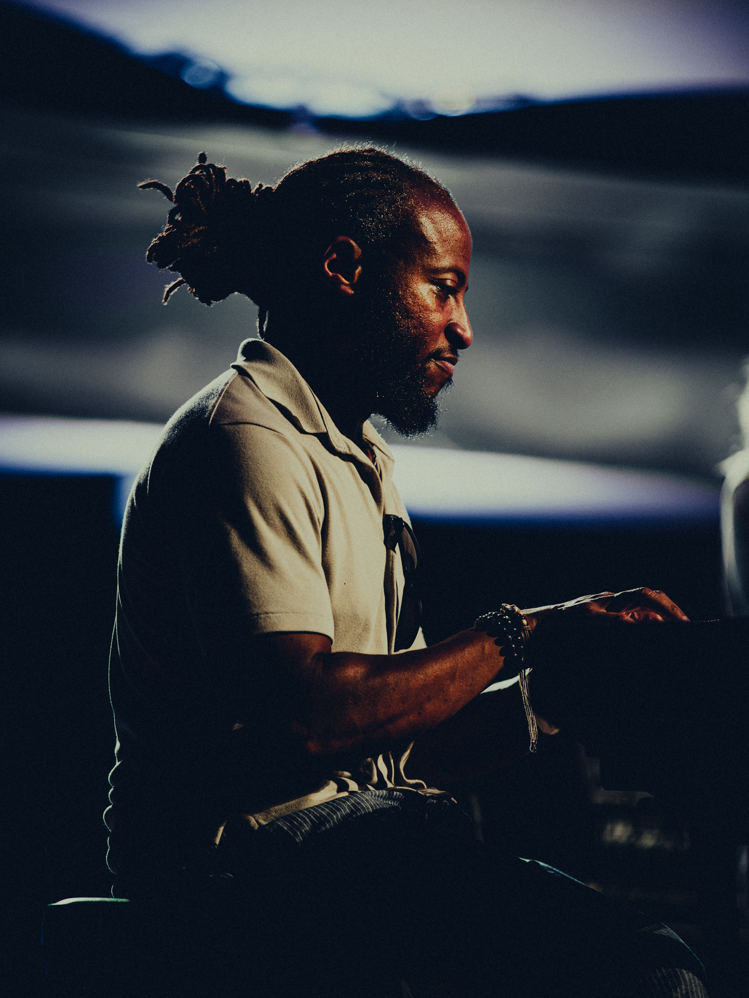 Pianist in profile under warm stage light