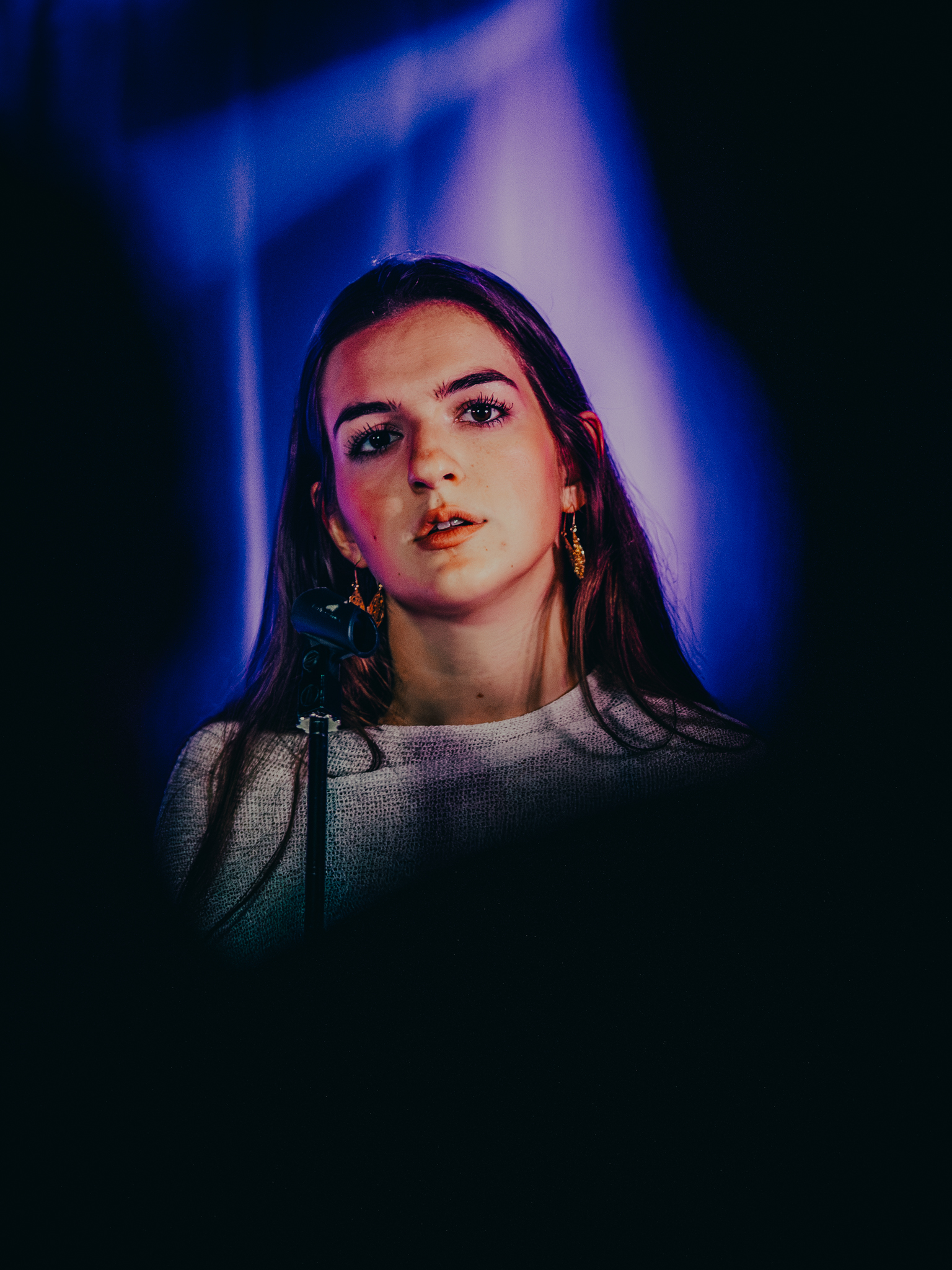 Vocalist under blue and purple stage light