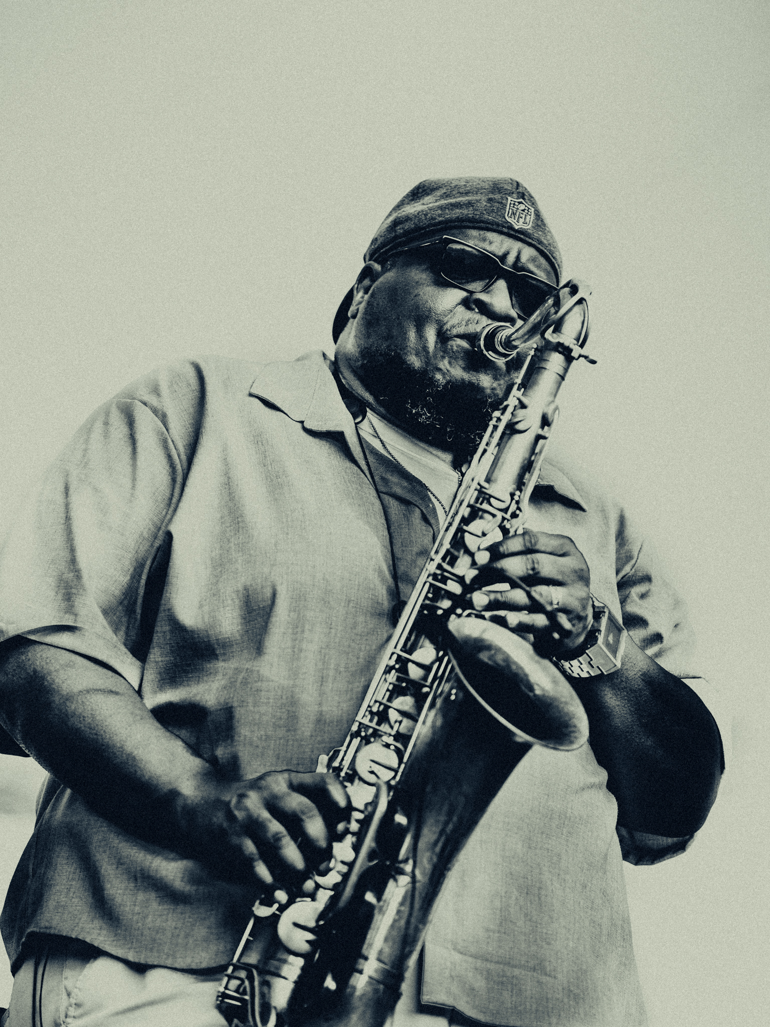 Saxophonist in sunglasses, photographed in monochrome