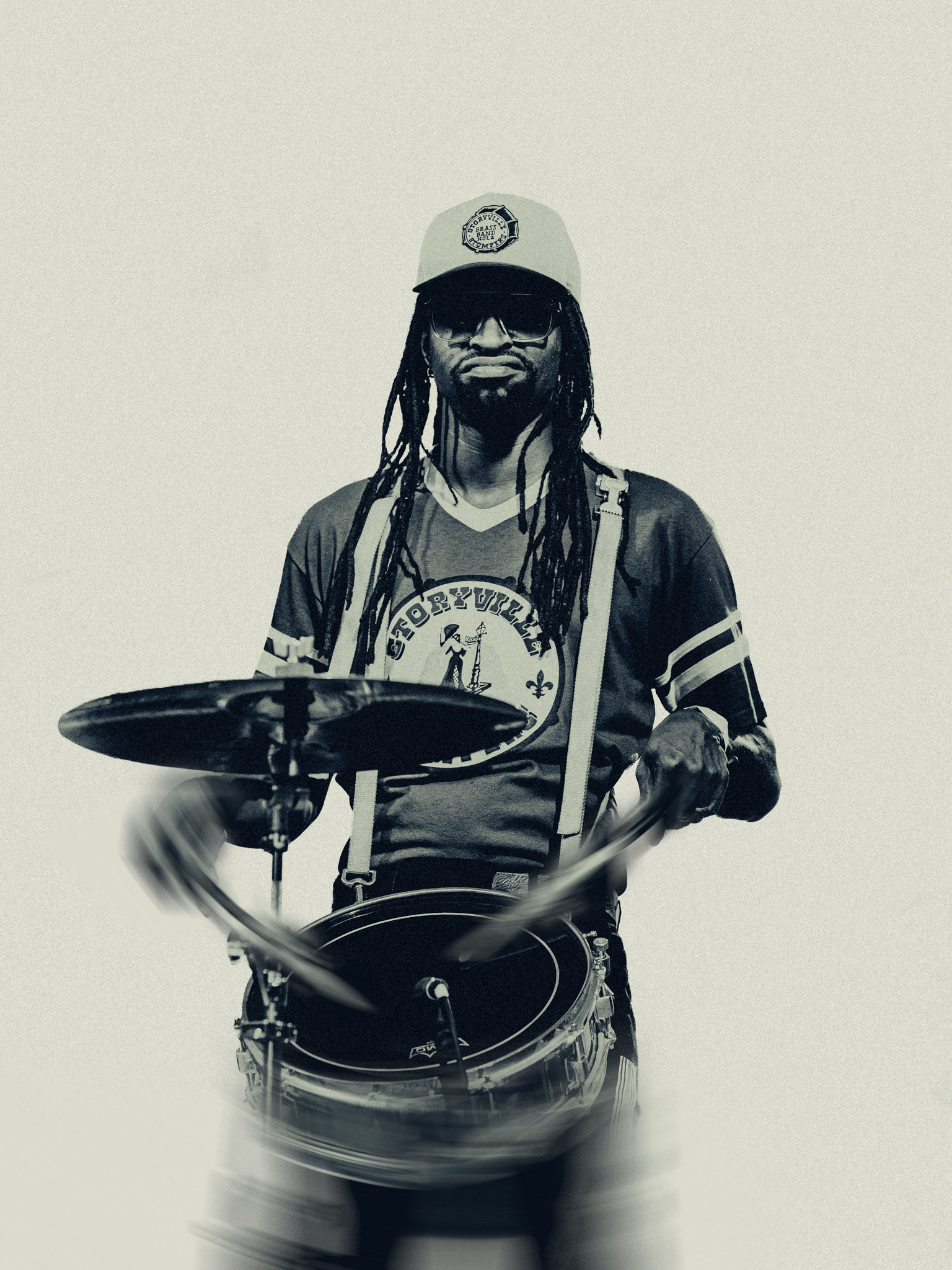 Monochrome portrait of a drummer with sticks in motion