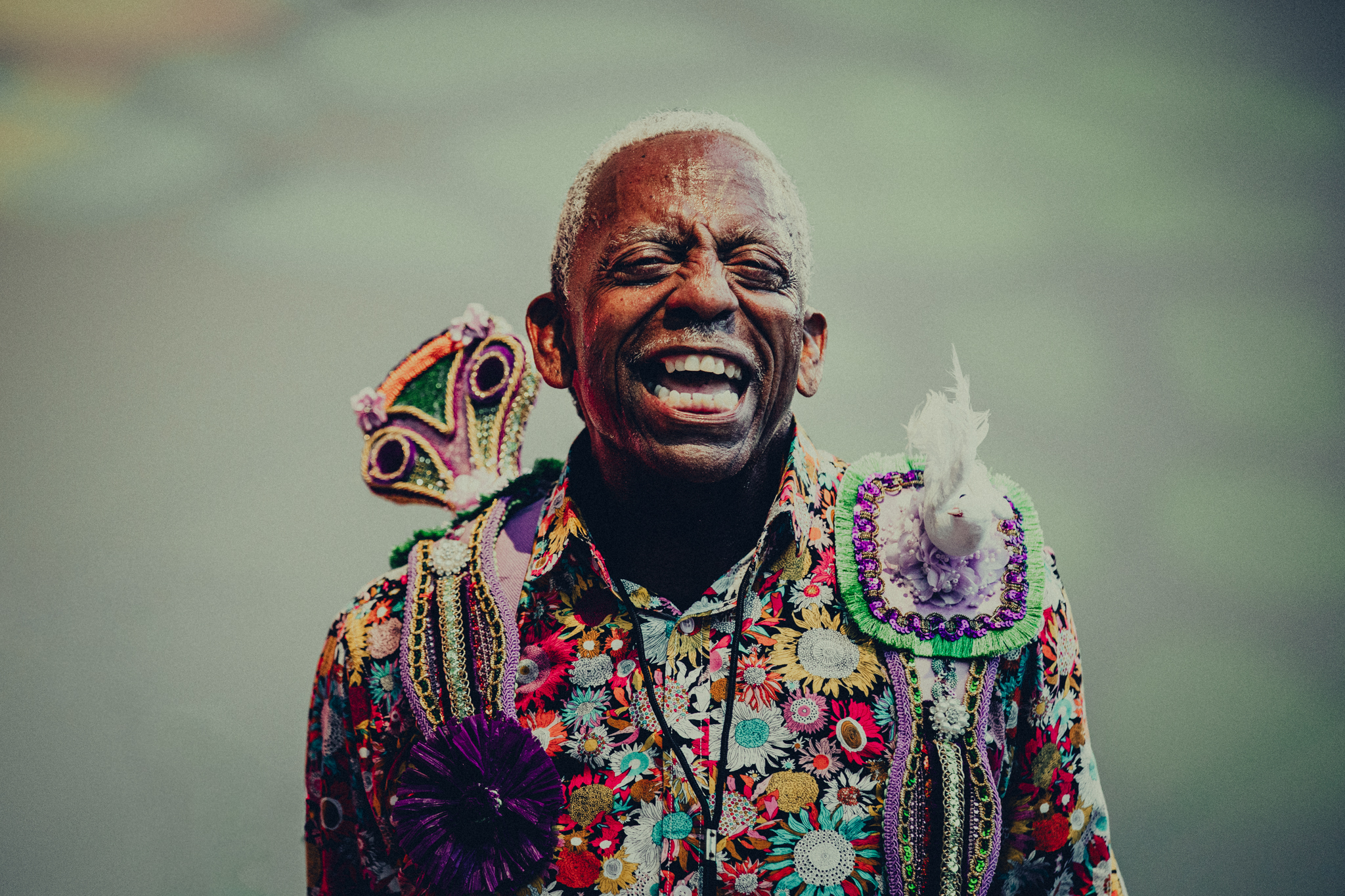 Smiling performer in a colorful embellished jacket