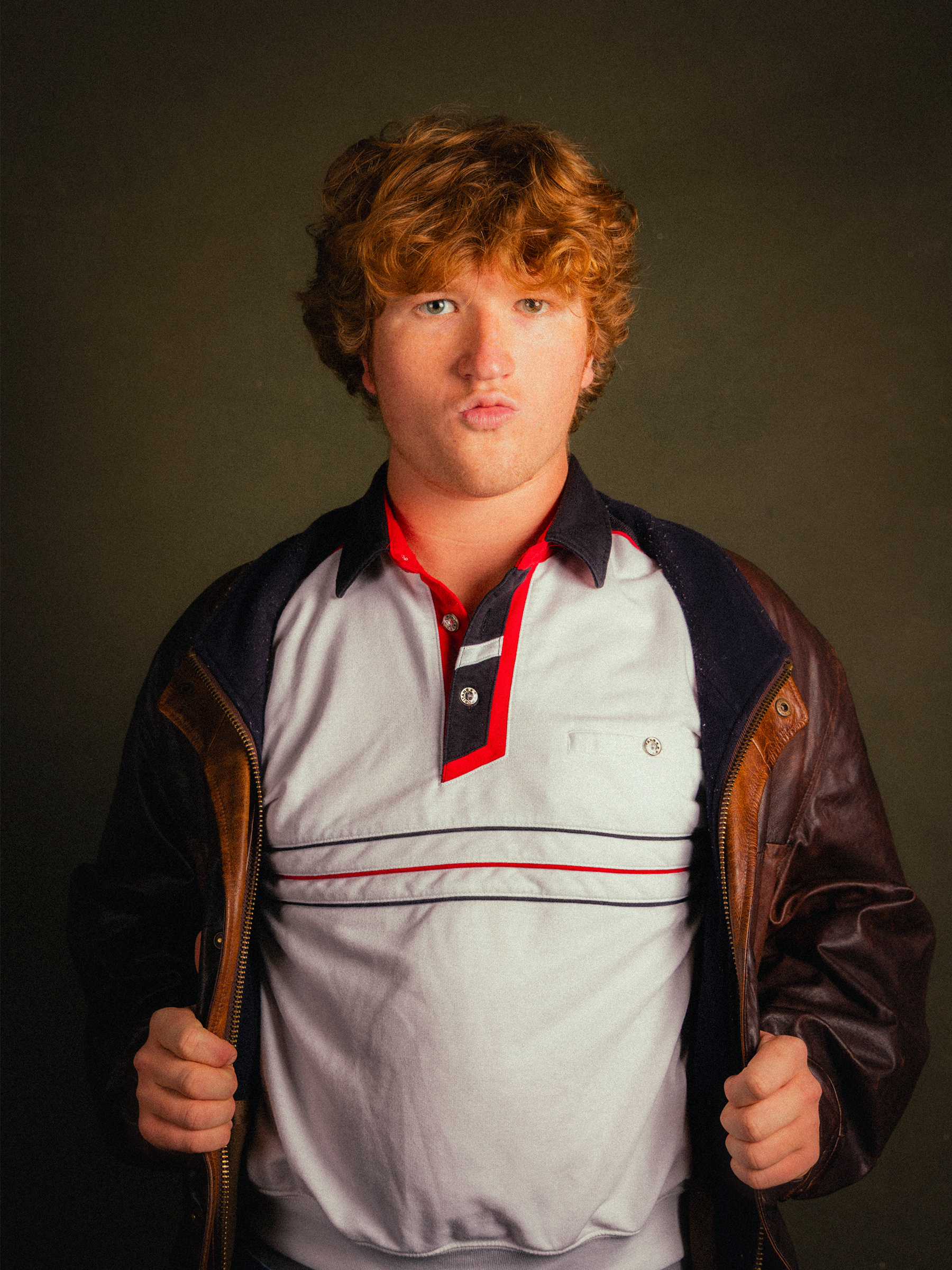Studio portrait in a leather jacket and striped polo